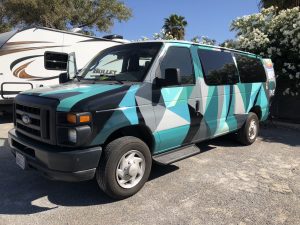 alt="camper van with mosaic body paint decoration"