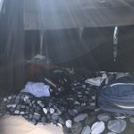 alt="inside of the van with the bed made up"