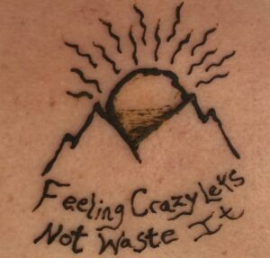 alt="henna tattoo of a mountain & song lyrics"