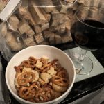alt="snacks in a bowl with a glass of wine
