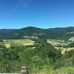 alt="valley floor with green fields"