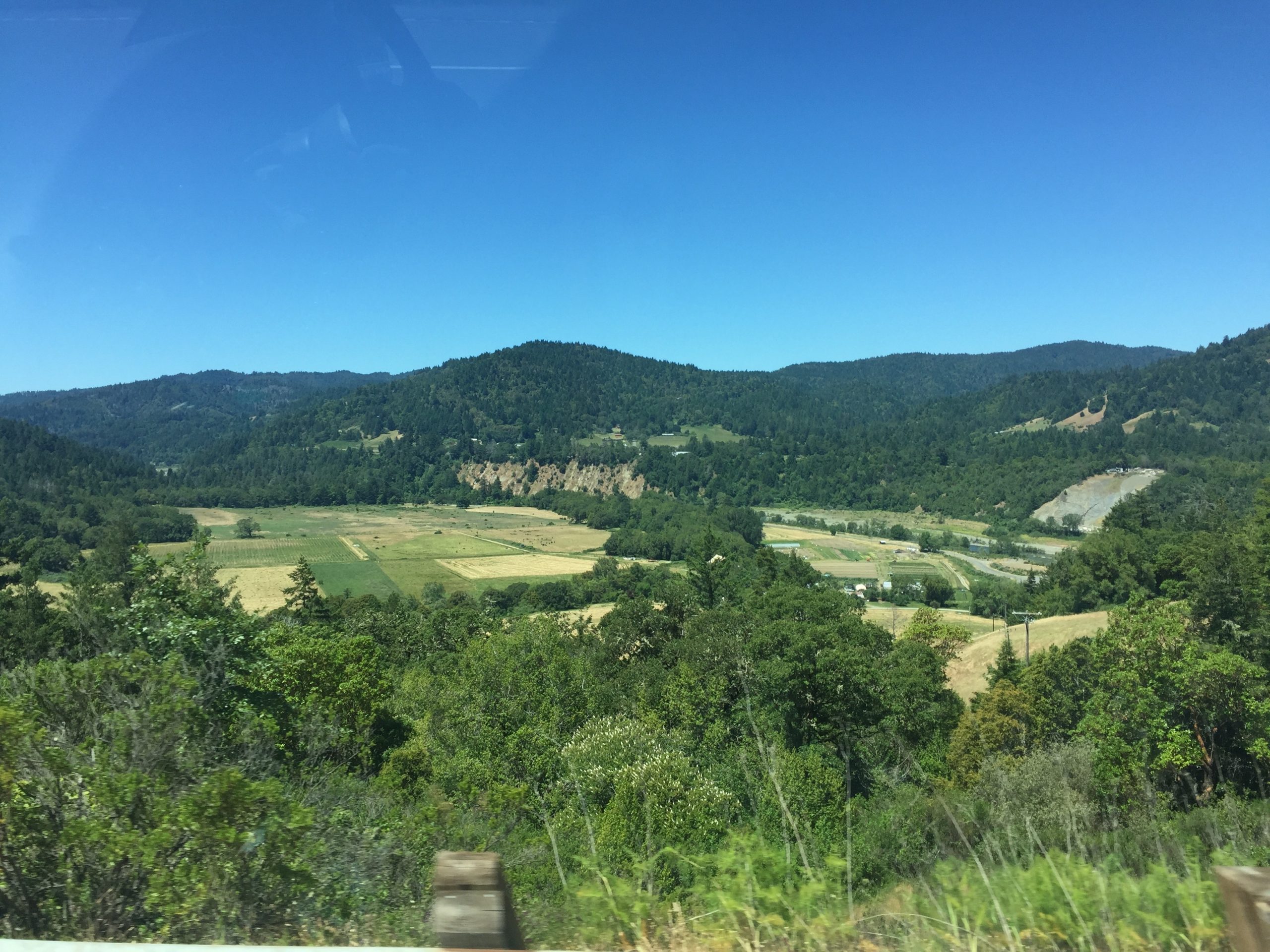 alt="valley floor with green fields"