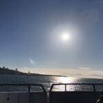 alt="sunset over back of boat"