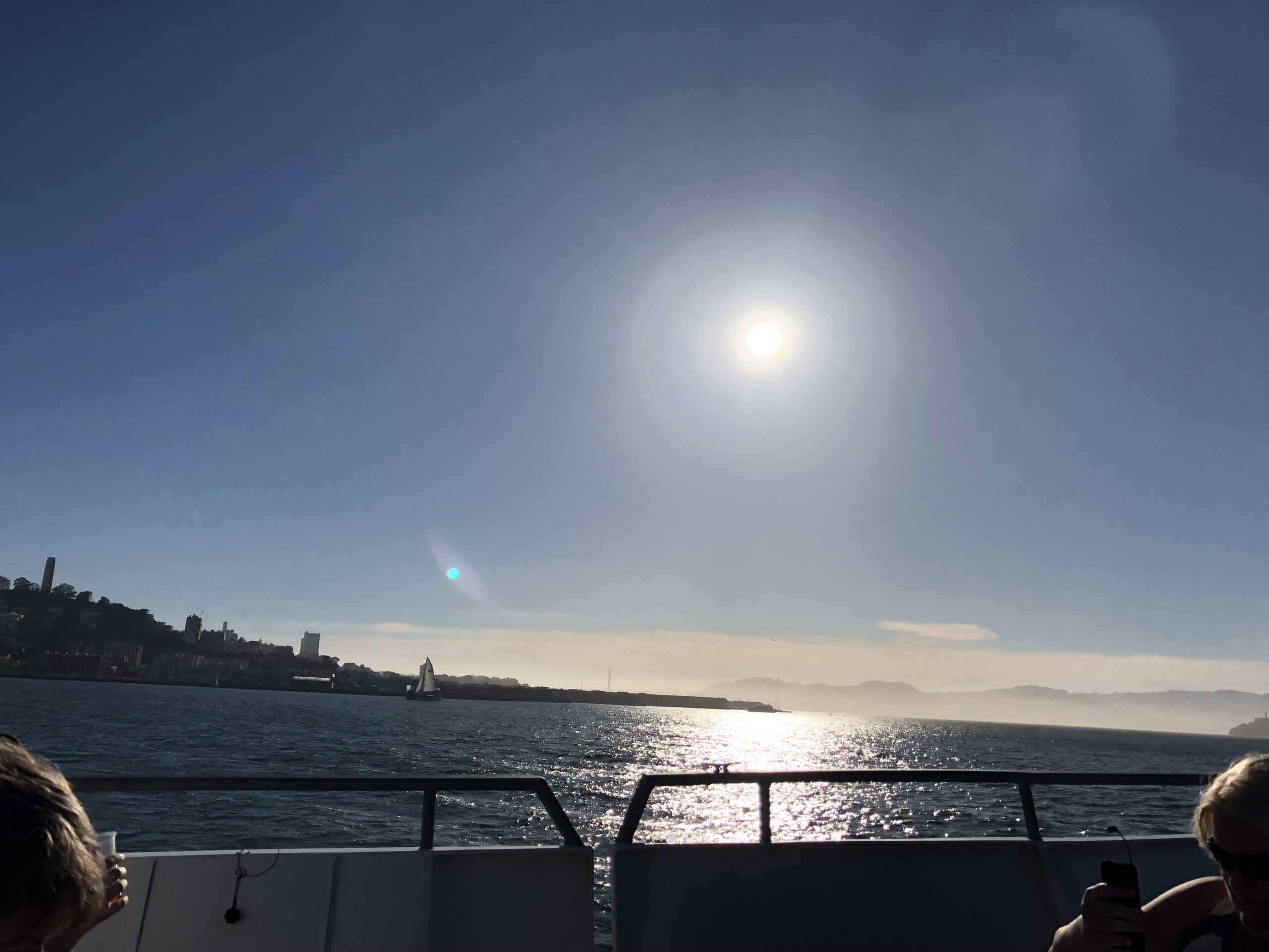 alt="sunset over back of boat"