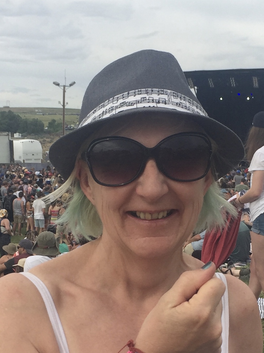 alt="a person wearing a hat & sunglasses"