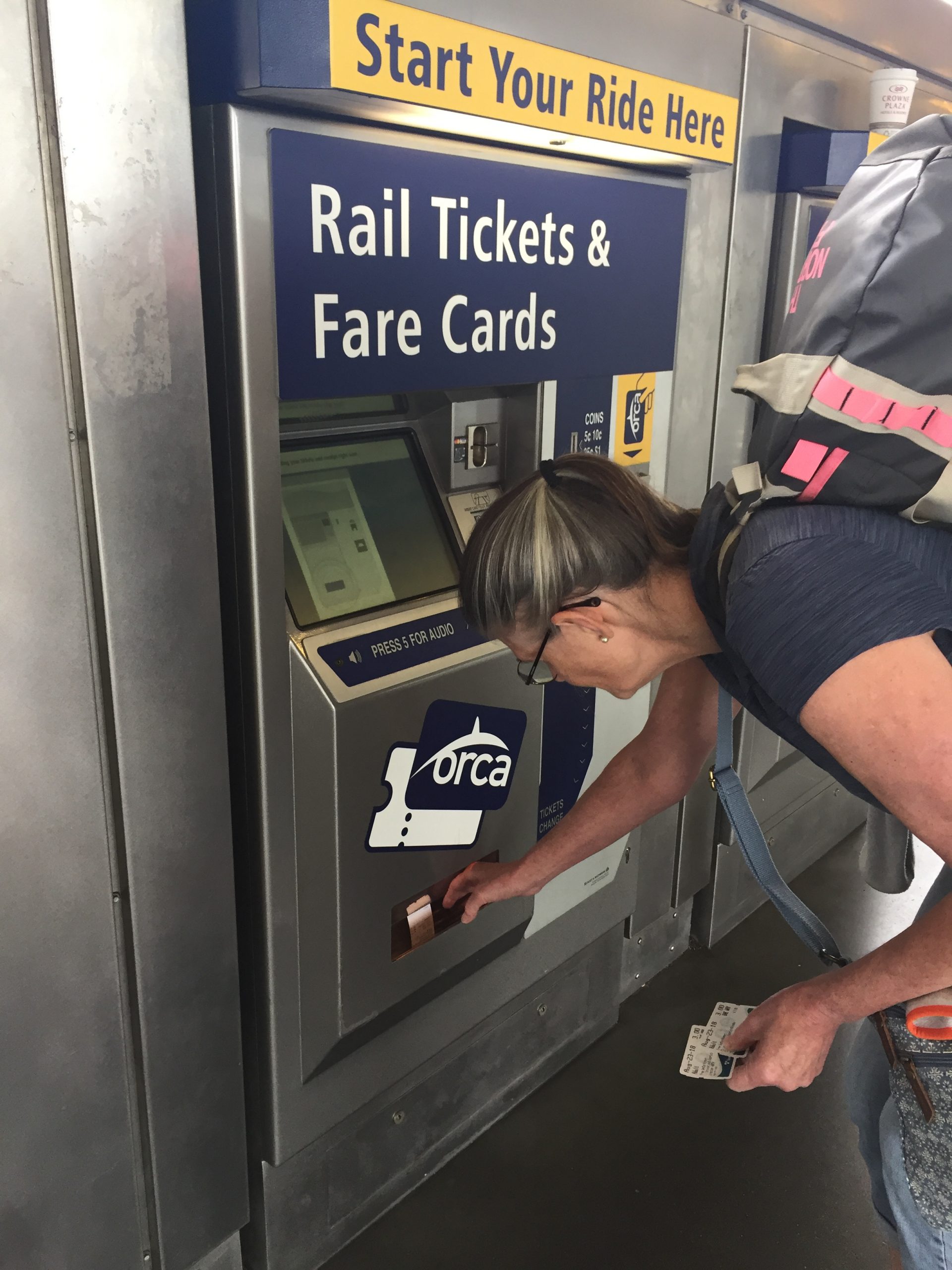 alt="buying tickets from a machine"