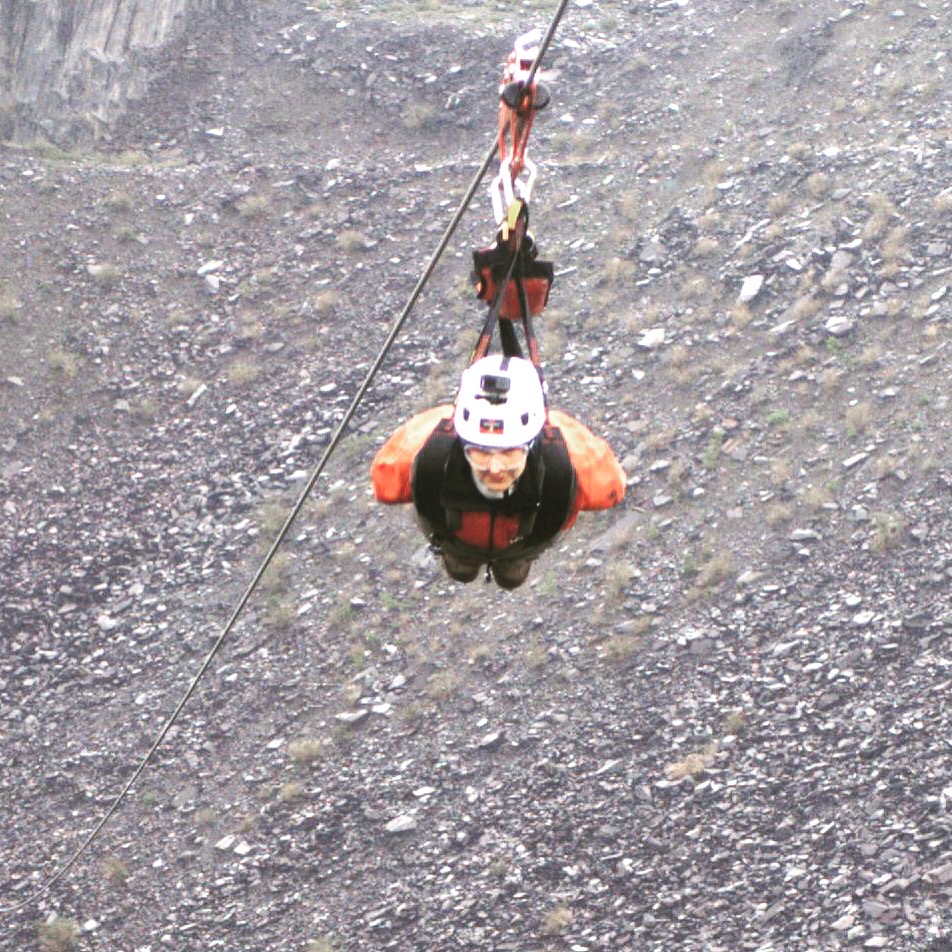 alt="me dangling on a harness doing the Velocity zipline"