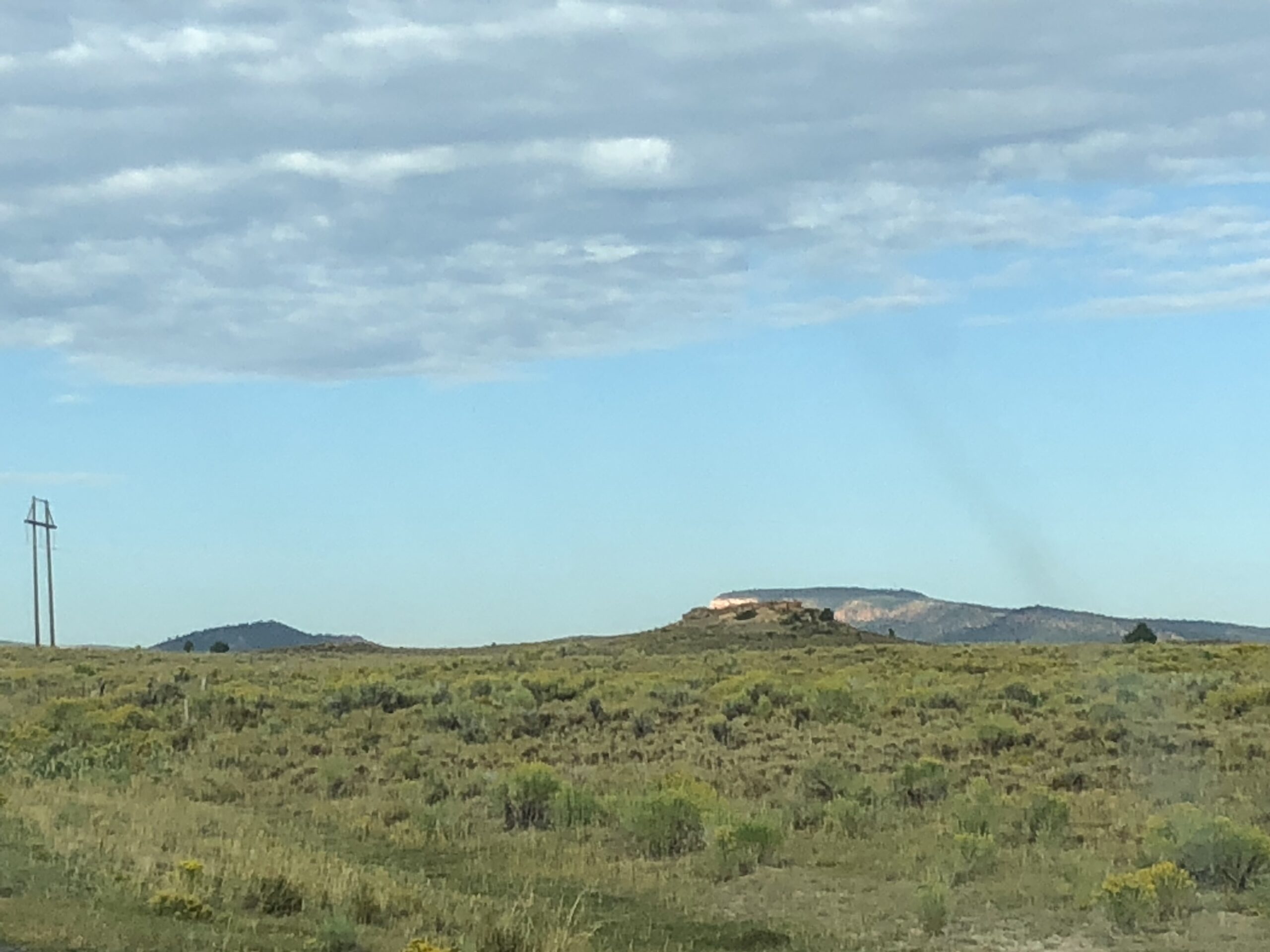 alt="grass land with mountain in distance"