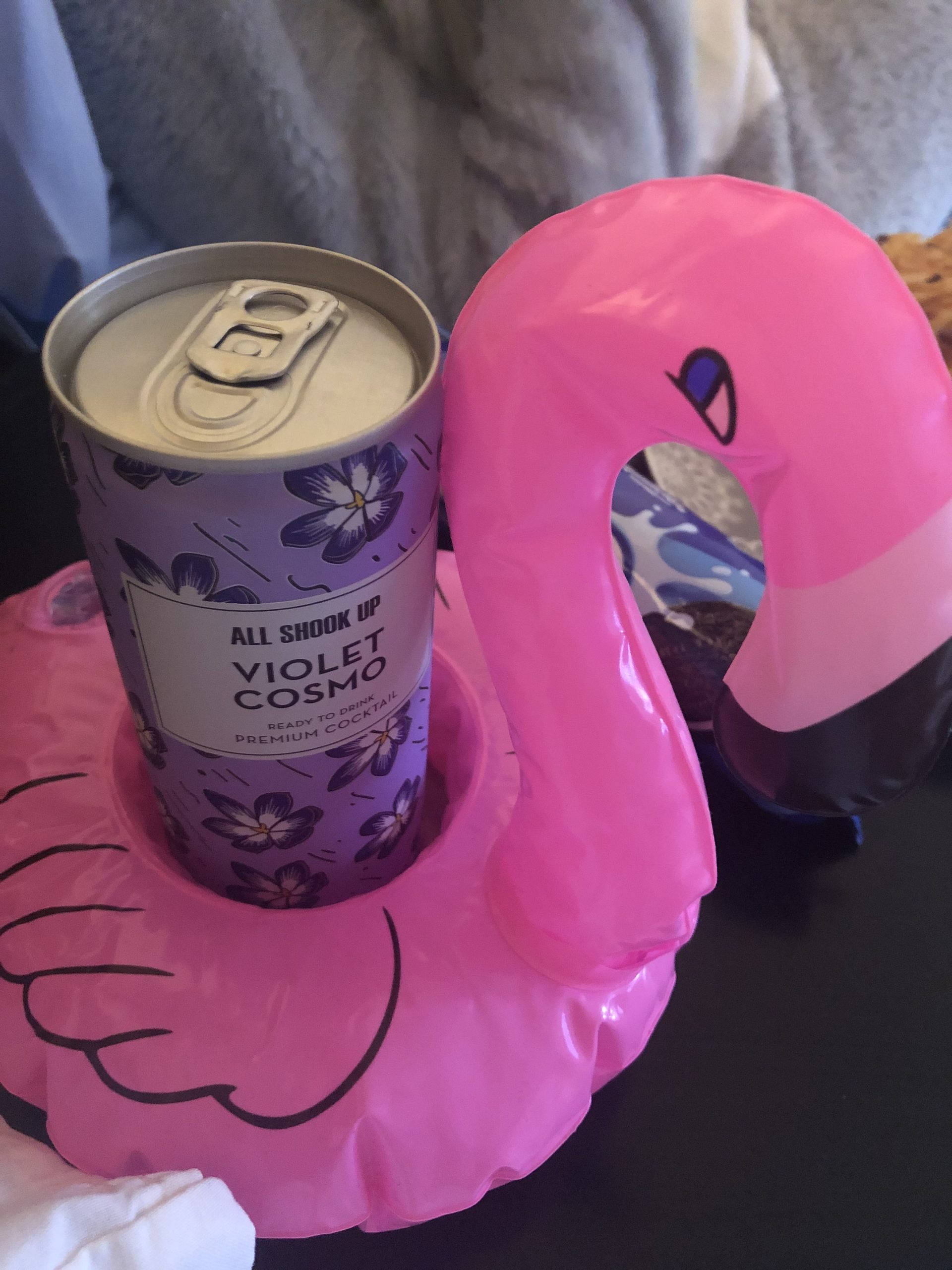 alt="tin inside a plastic flamingo drinks holder"