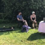 alt="two people sat in garden"