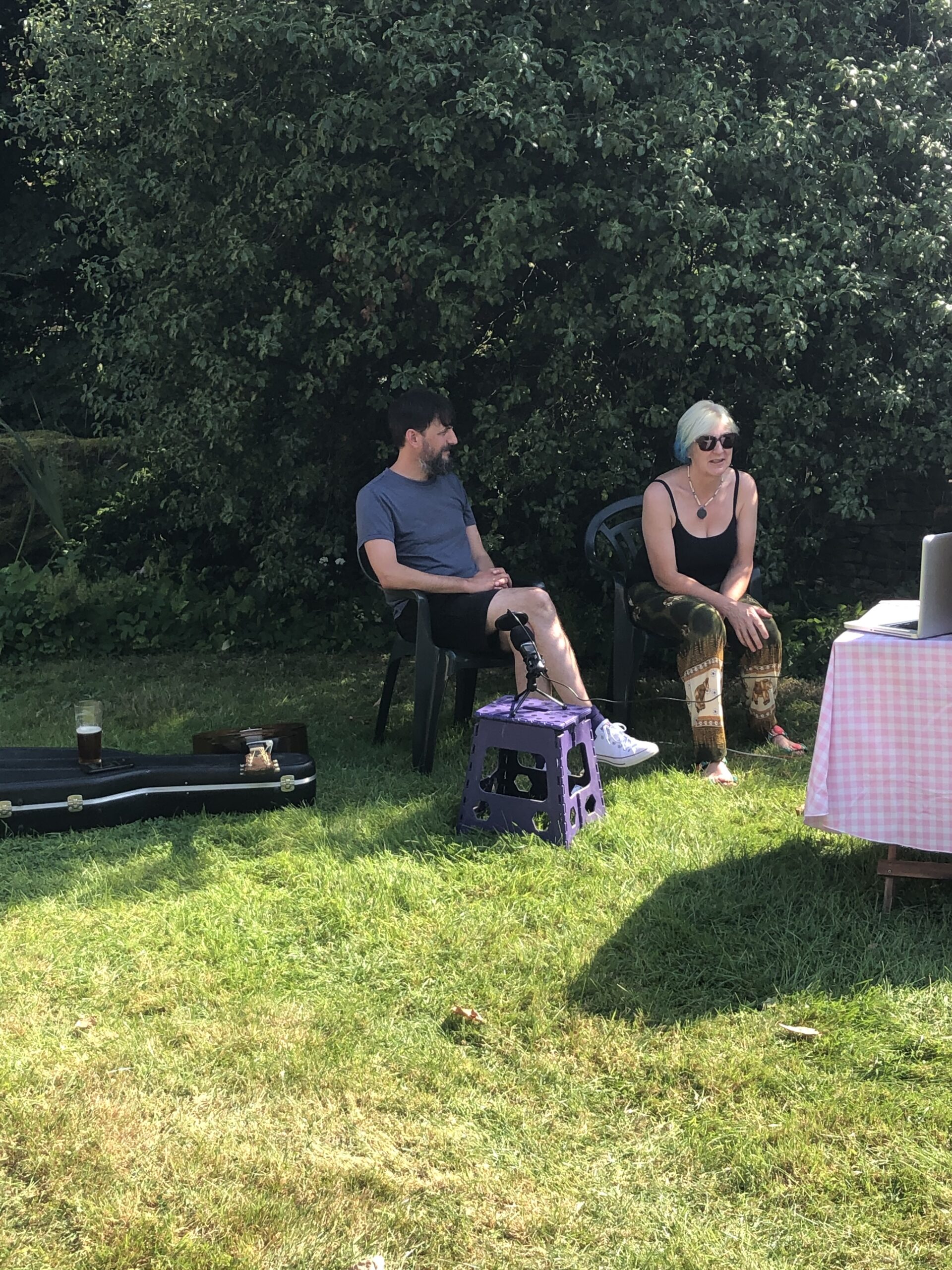 alt="two people sat in garden"
