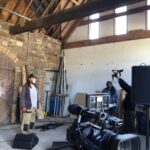 alt="people working with music recording equipment"