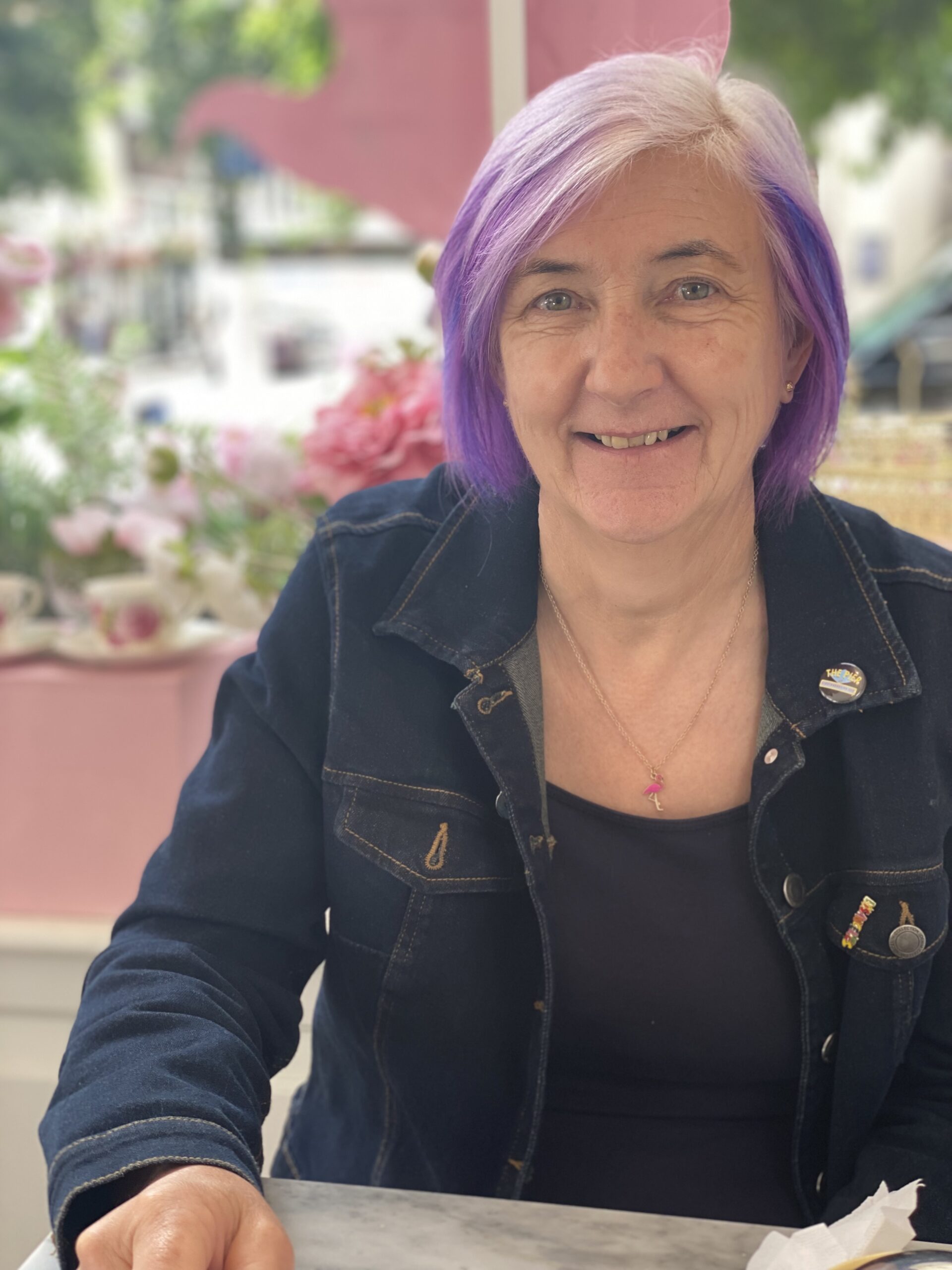 alt="person sat with denim jacket on"