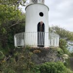 alt="person in arch doorway of tower"