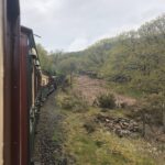 alt="view from train window looking along the train"