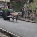 alt="railway station with bench"