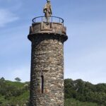 alt="tower with statue"