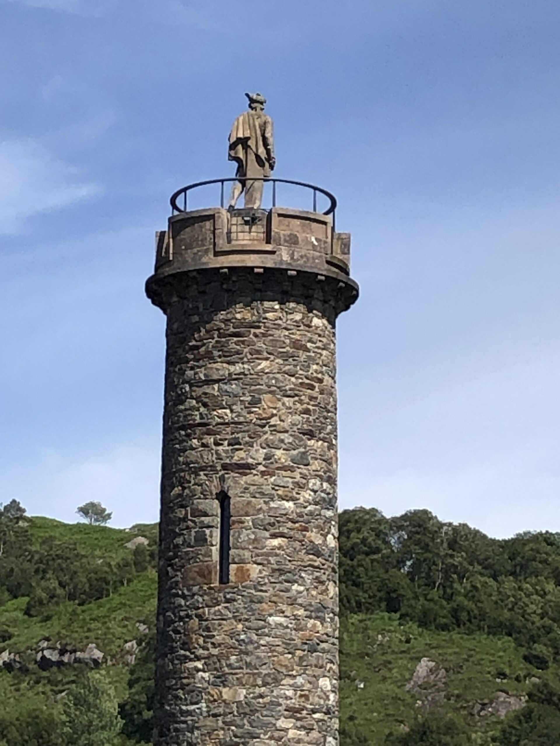 alt="tower with statue"