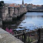 alt="old stone bridge across river"