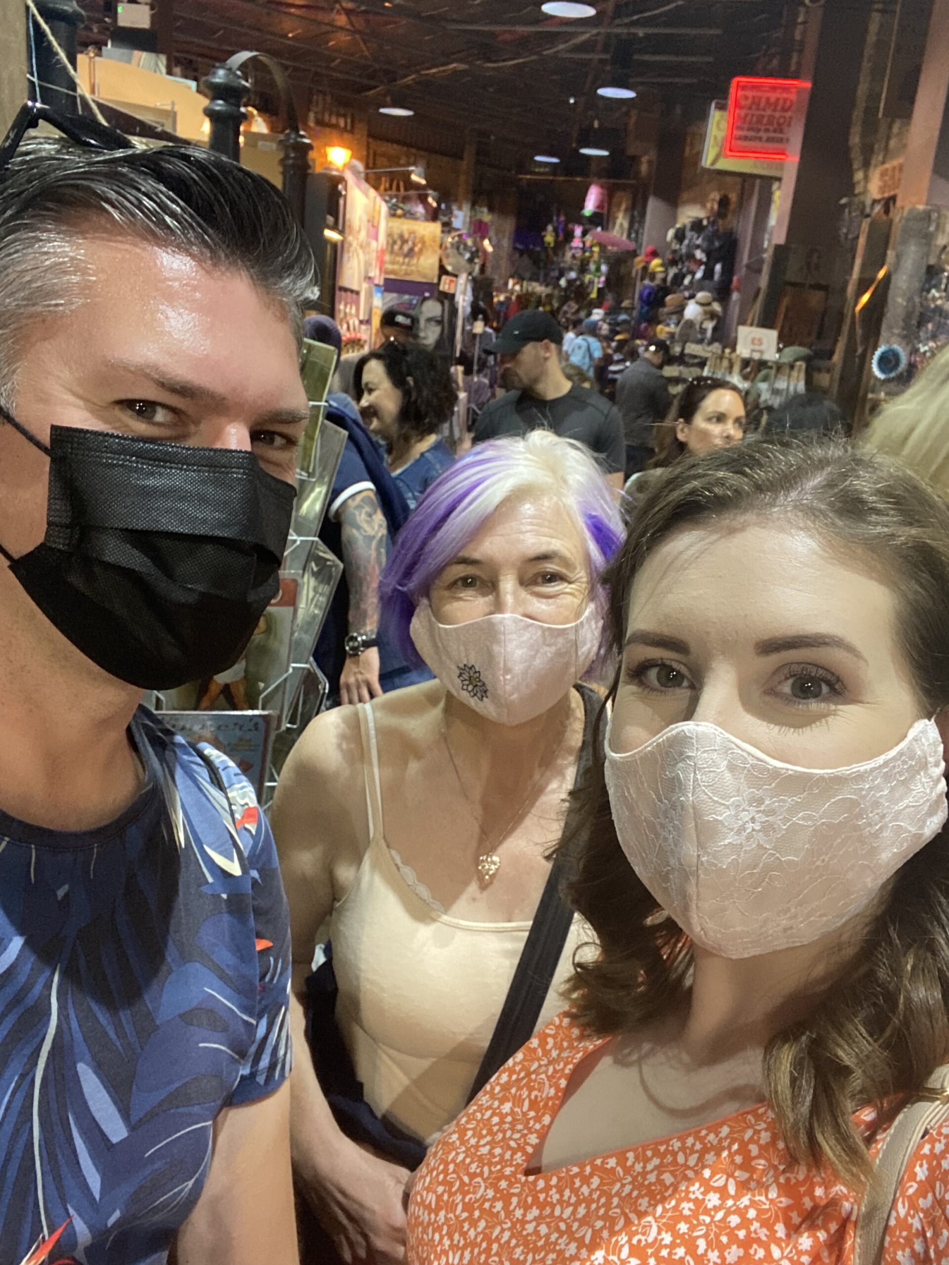 alt="three people with masks on"