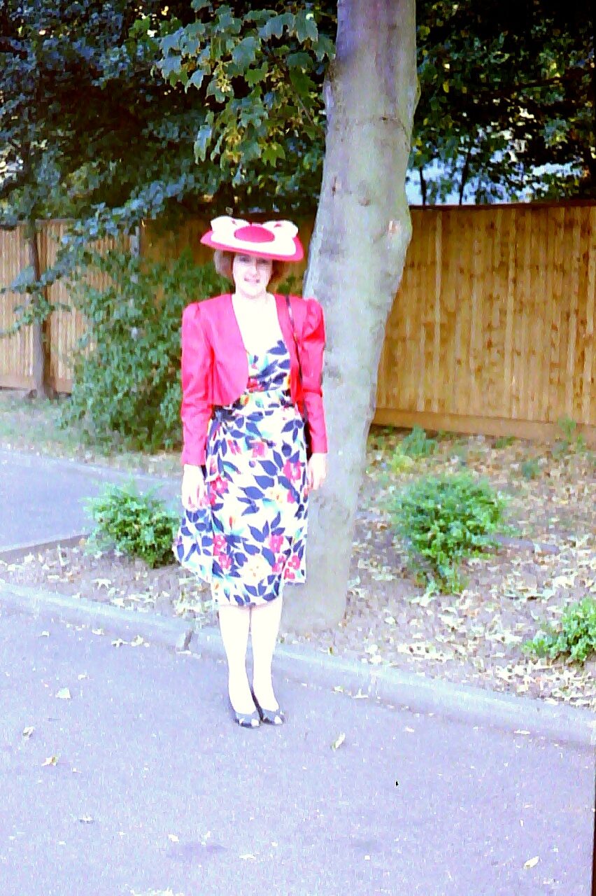 alt="person in dress & hat"