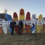 alt="row of coloured surf boards & the letters Boardmasters"