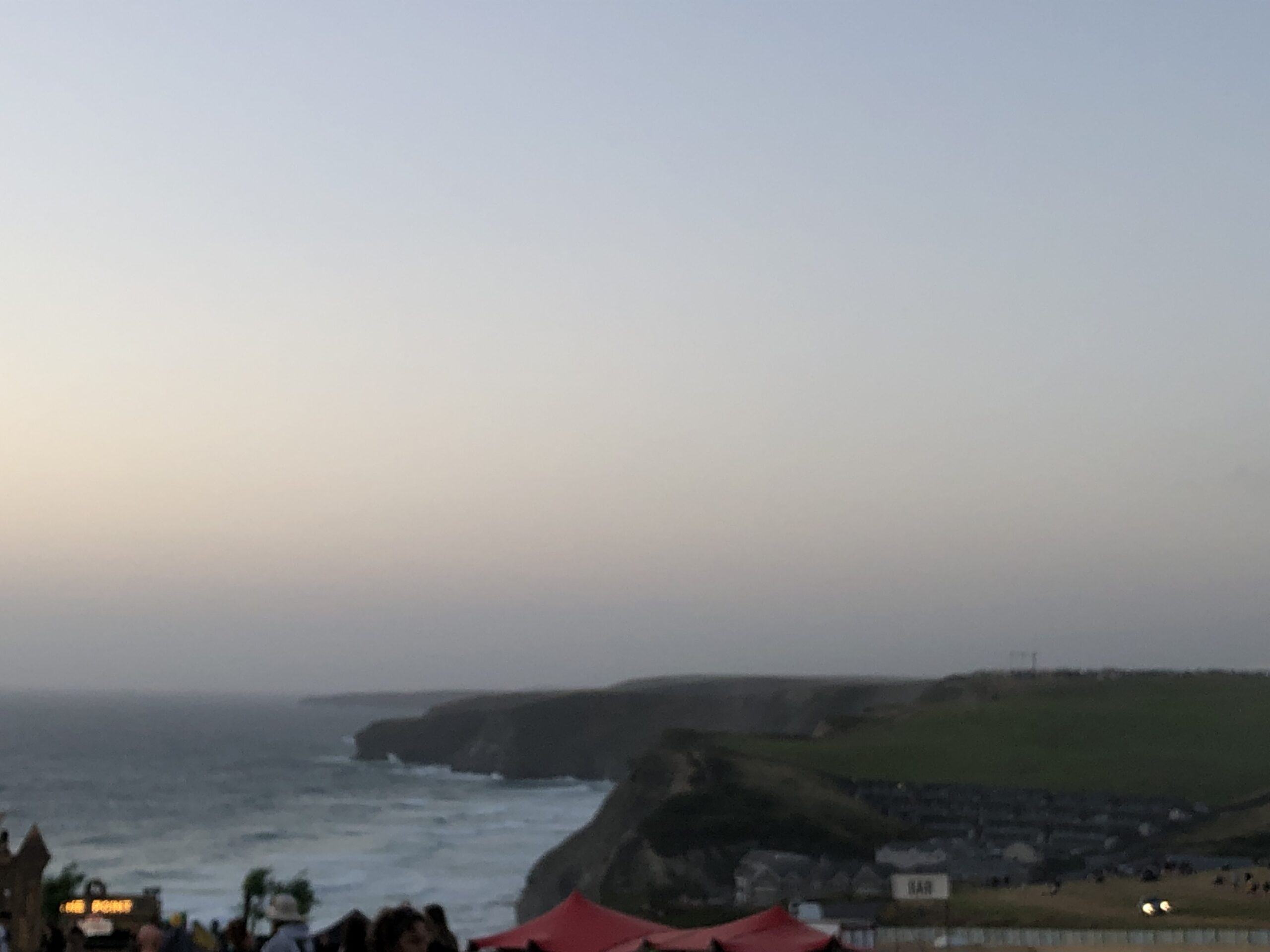 alt="looking from the cliff across the headland & sea"