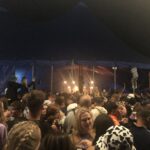 alt="lots of people crowded in a tent"