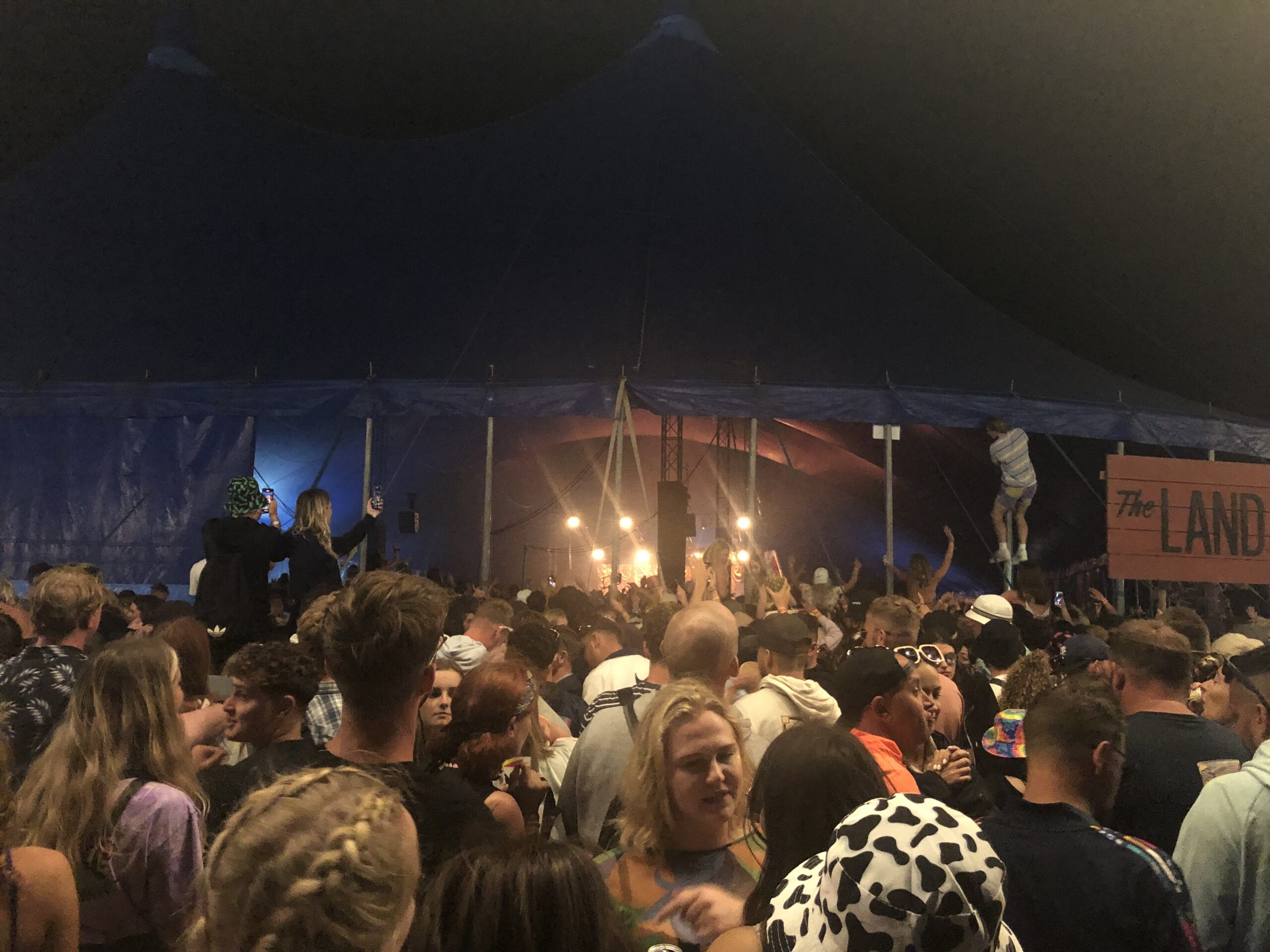 alt="lots of people crowded in a tent"