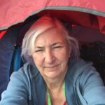 alt="person sat in small tent"