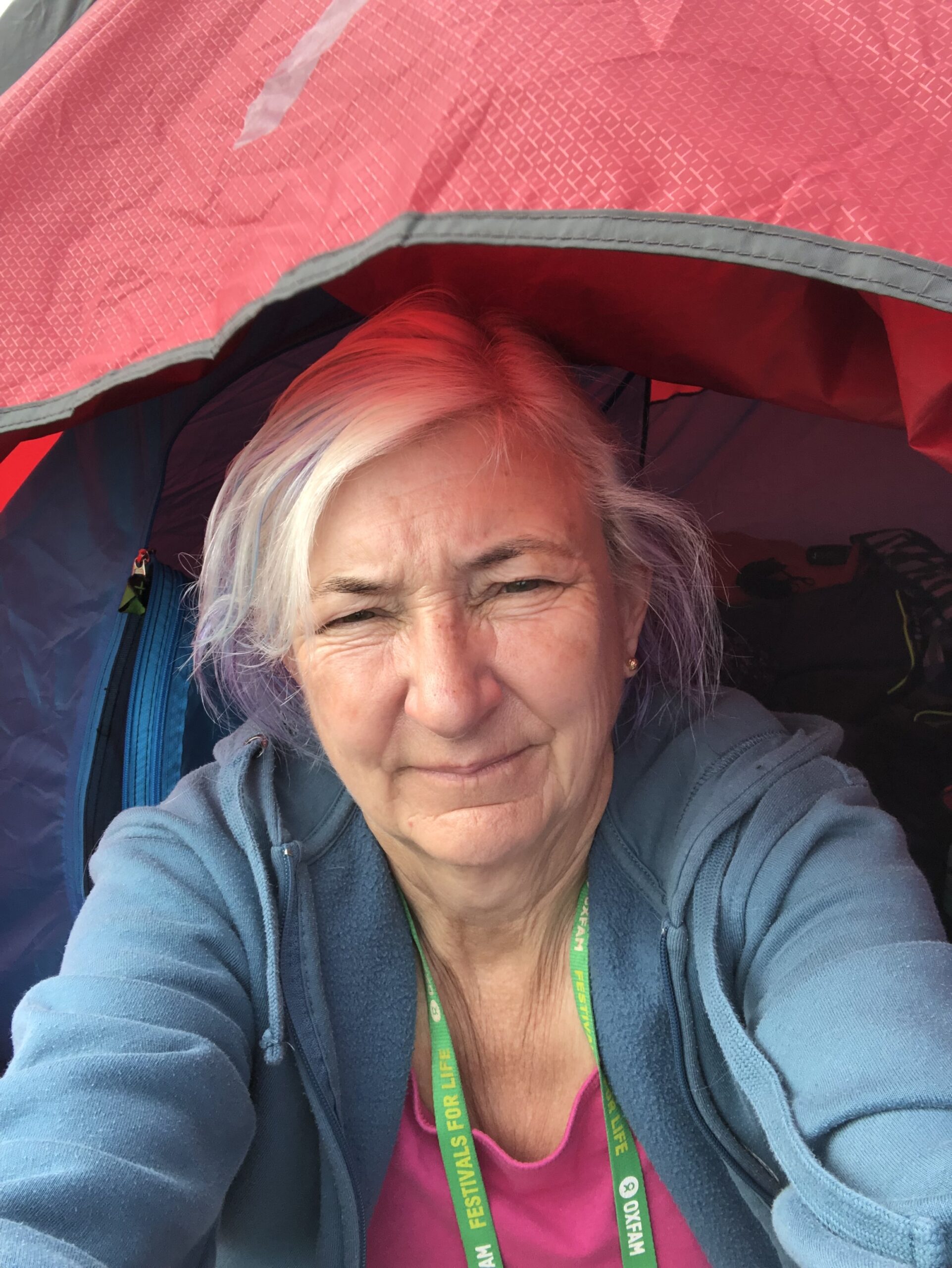 alt="person sat in small tent"