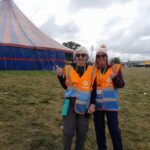 alt="two people with oxfam steward tabards on"