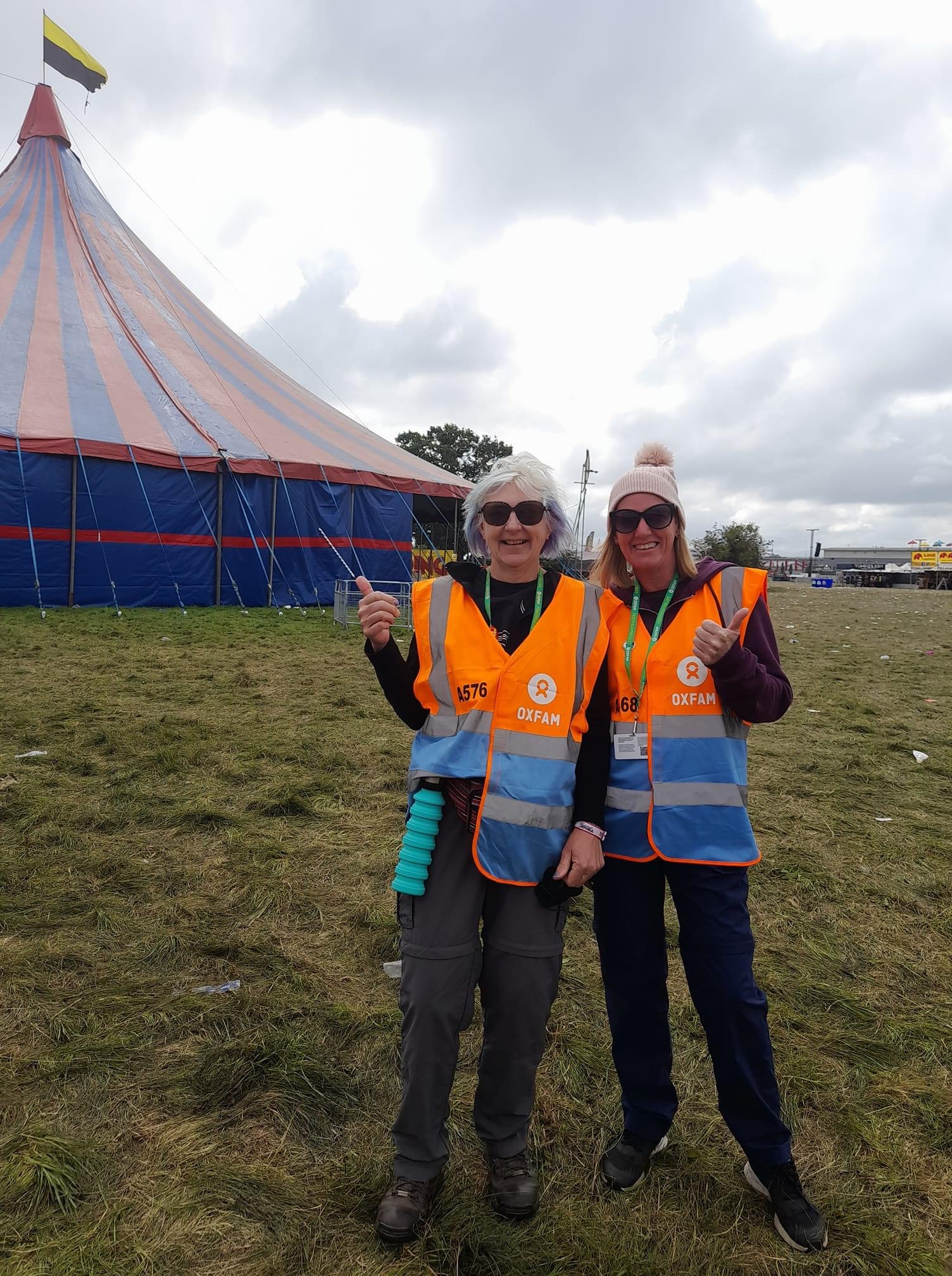 alt="two people with oxfam steward tabards on"