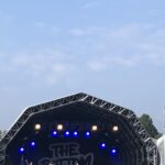 alt="top of main stage awning with crowd"