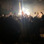 alt="singer on top od crowd shoulders"