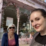 alt="two people sat at cafe table"