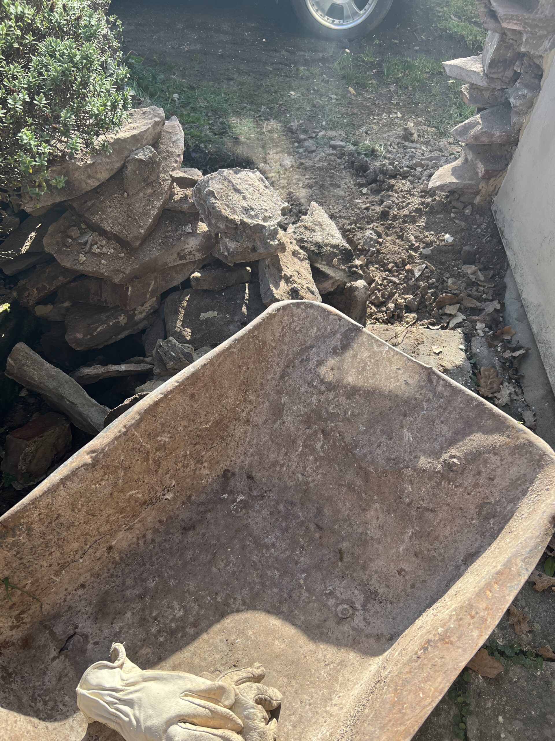 alt="wheel barrow & wall