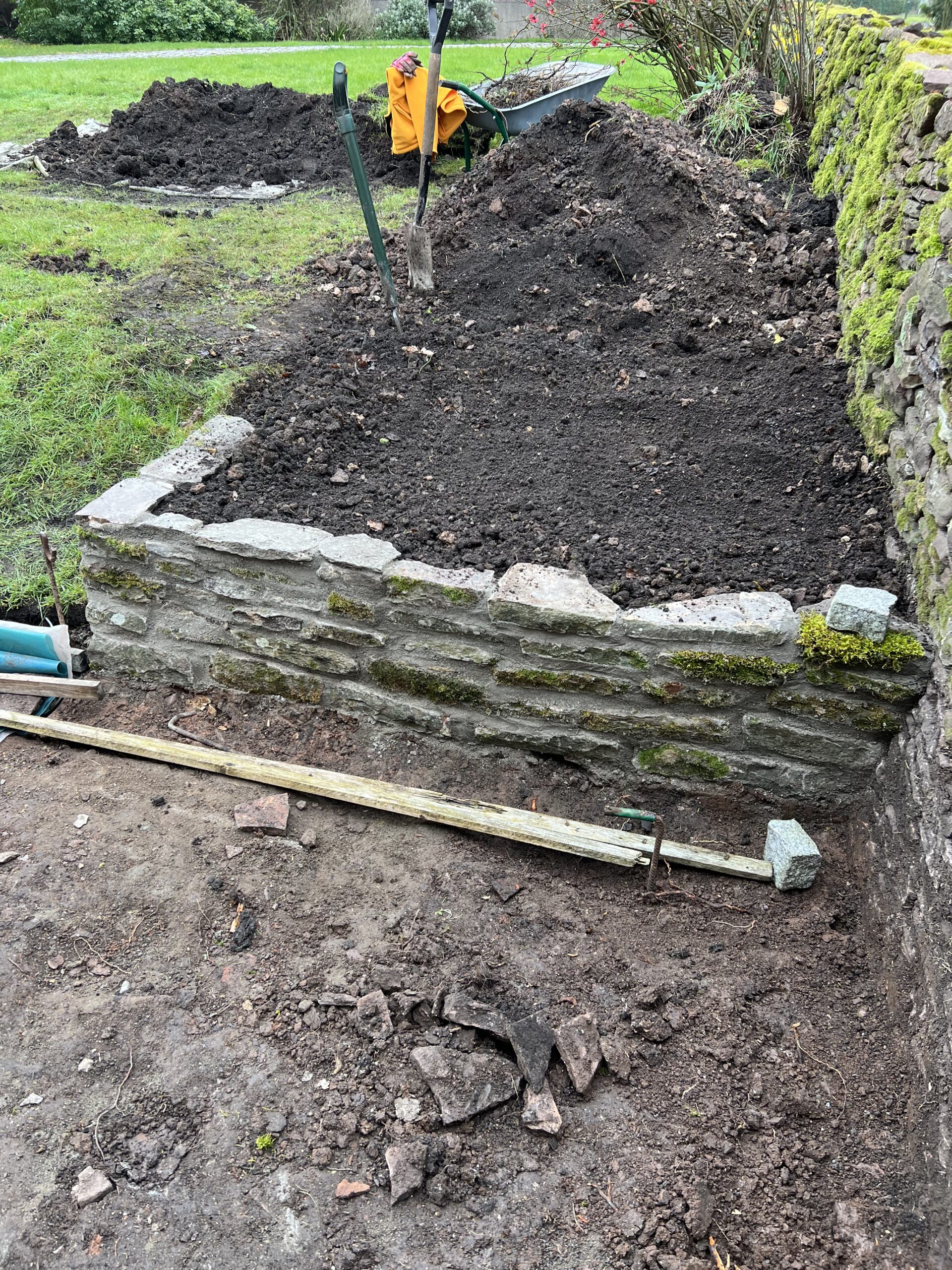 alt="new wall for flower bed"