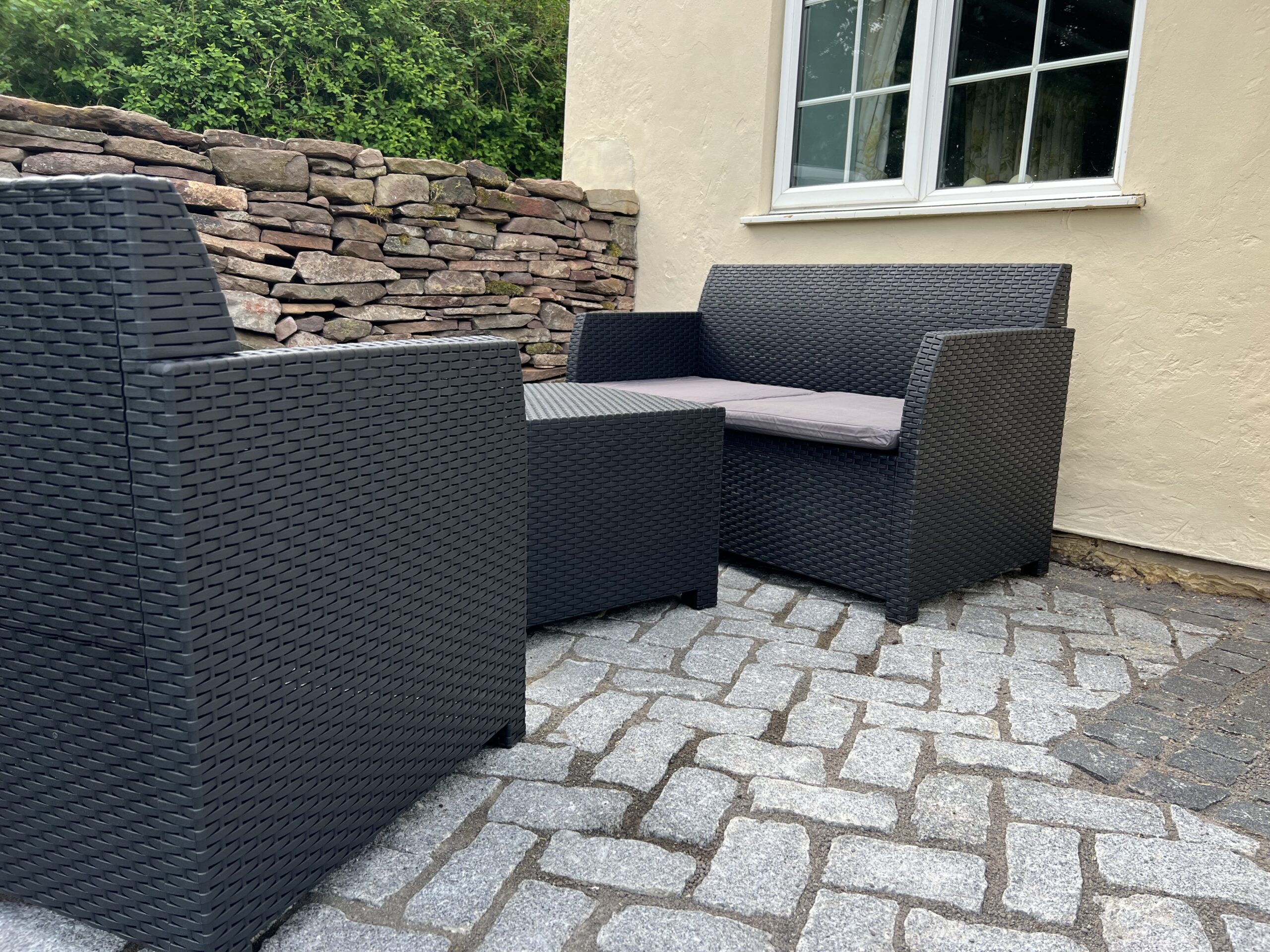alt="new wall with patio furniture"