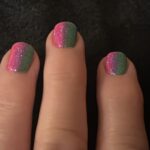 alt="fingers with two nail polish colours"