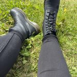 alt="two legs with black jeans & doc marten boots"
