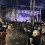 alt="inside a tent with stage & crowd"
