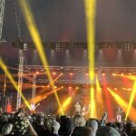 alt="light show on stage as band performs"