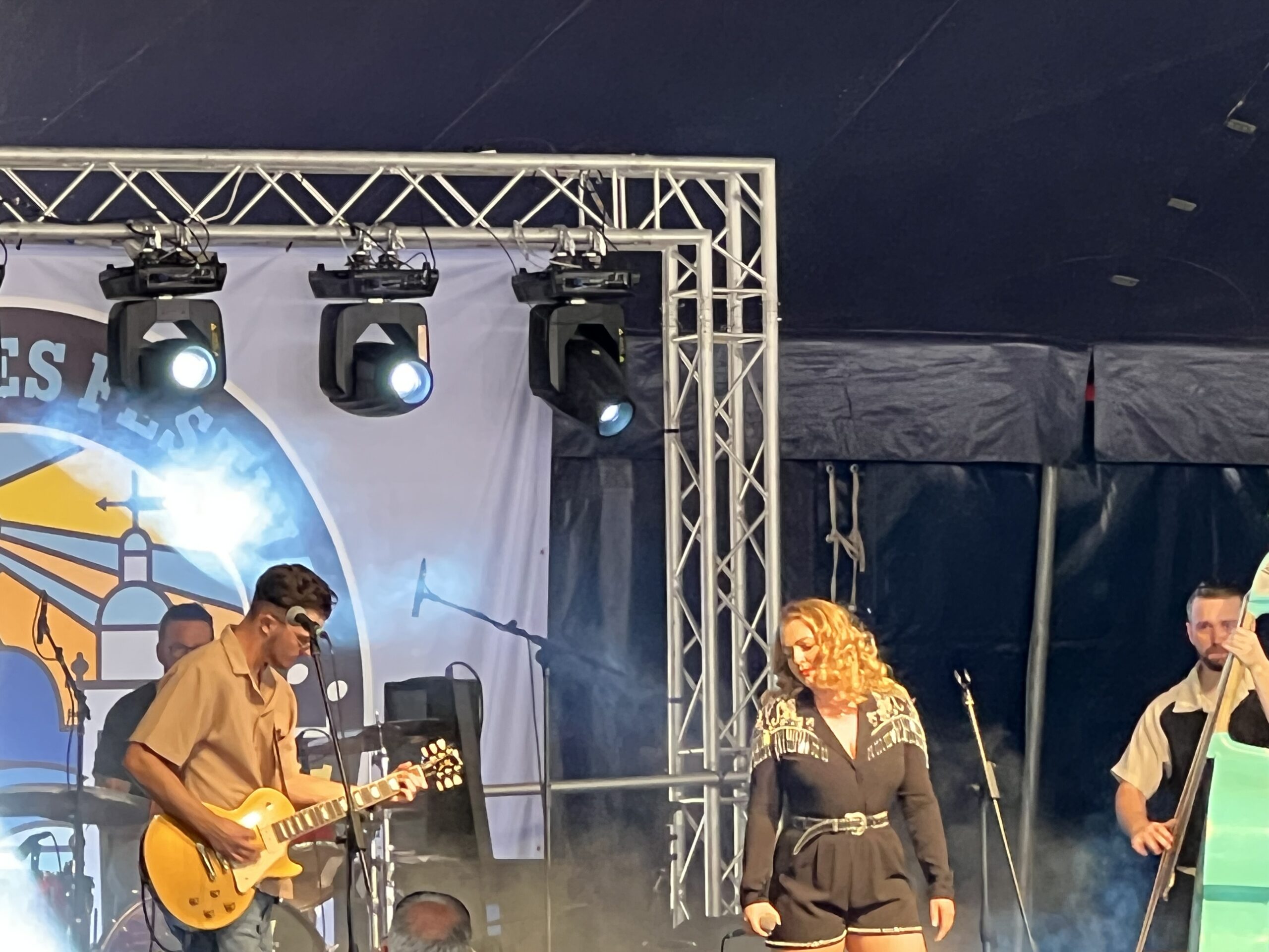 alt="two musicians in front of stage"