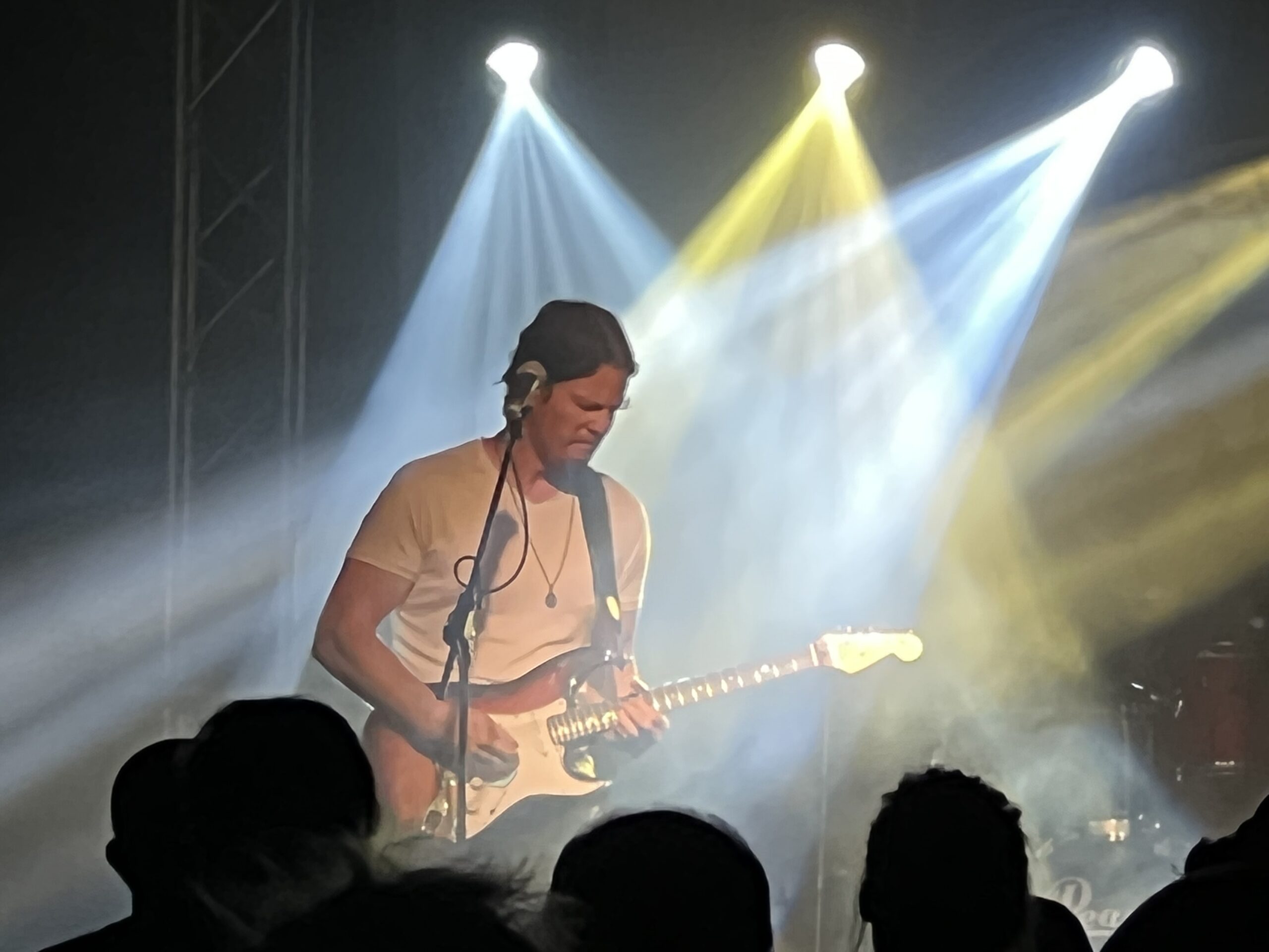 alt="person playing guitar with light effects"