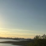 alt="lake with shore at dusk"