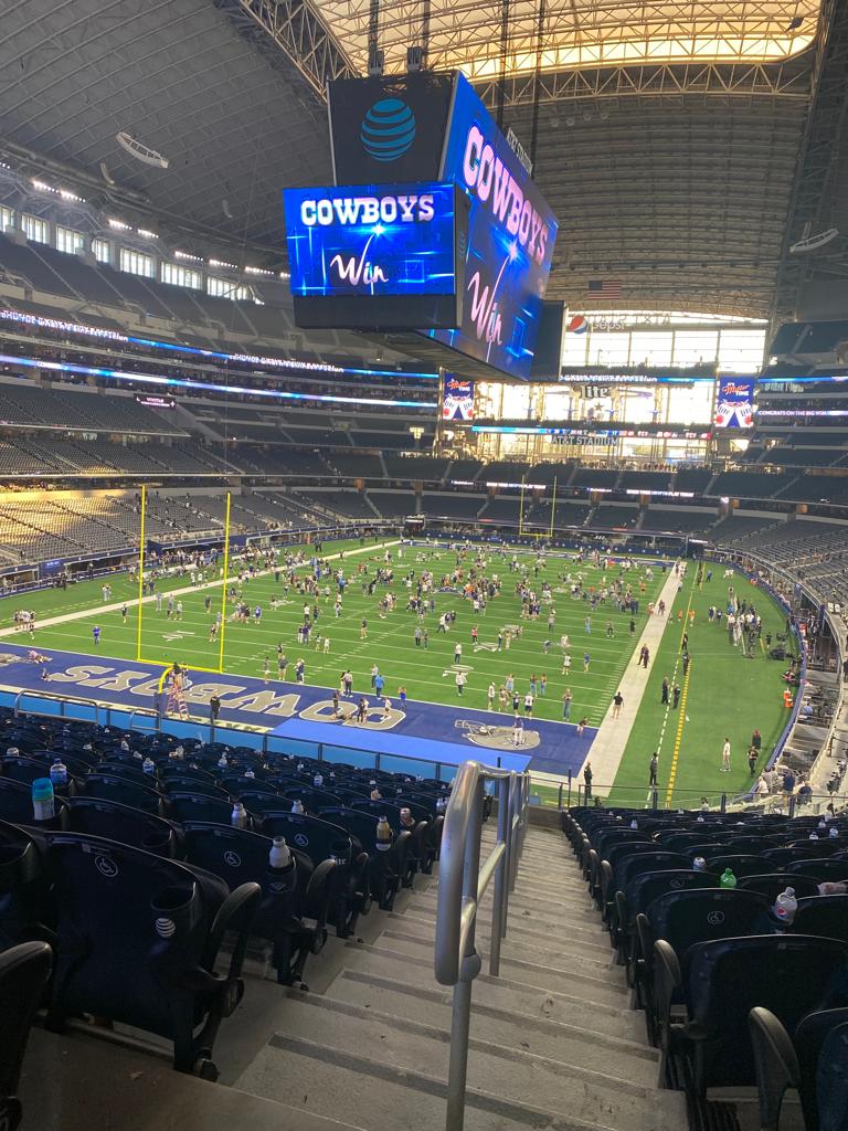 alt="the pitch & seating inside the Dallas Cowboys stadium"
