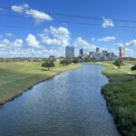 alt="channel of water with buildings in distance"