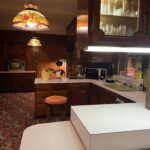 alt="kitchen units with glass lampshade"