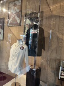 alt="martial arts clothes in glass case"